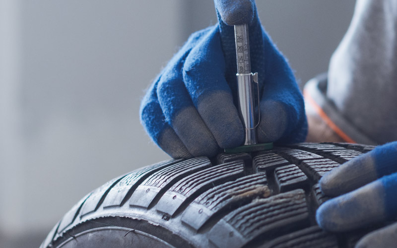 Tyre tread depth being checked